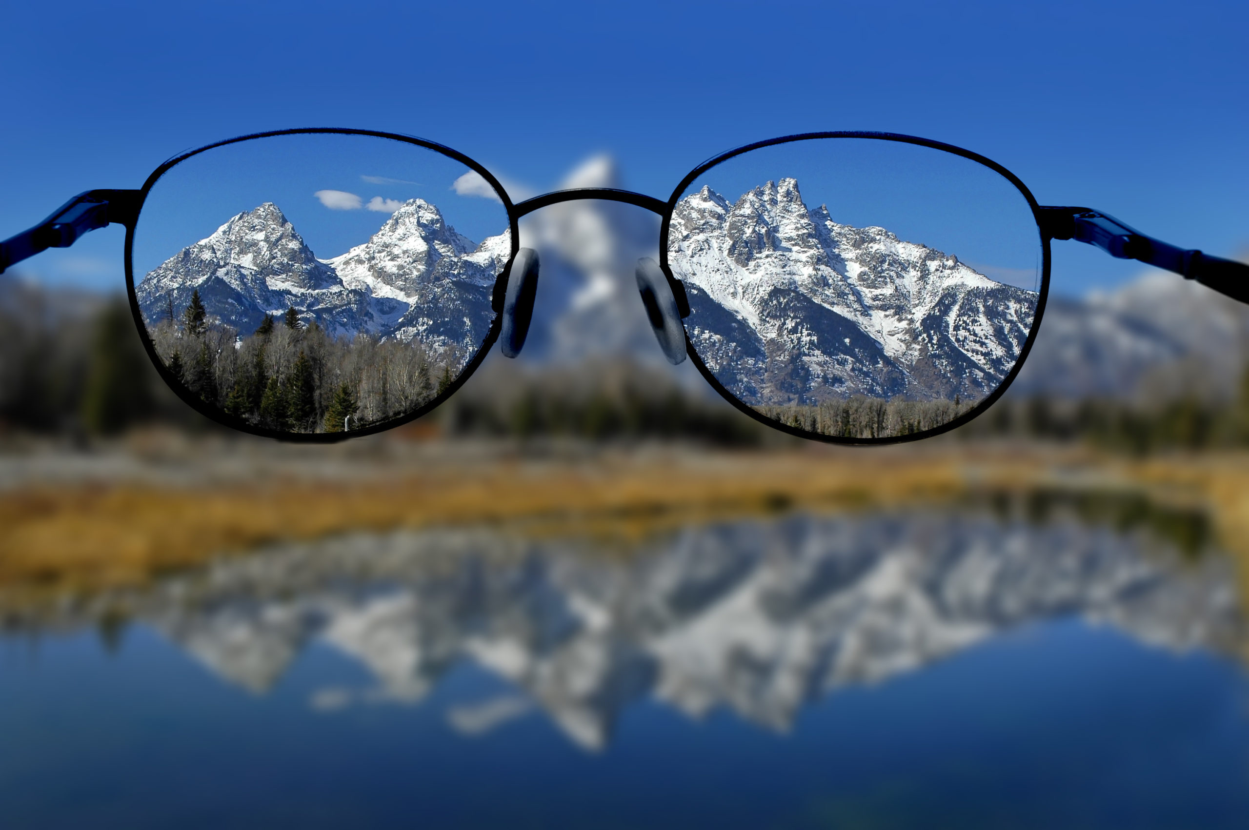 large pair of glasses sitting on mountains