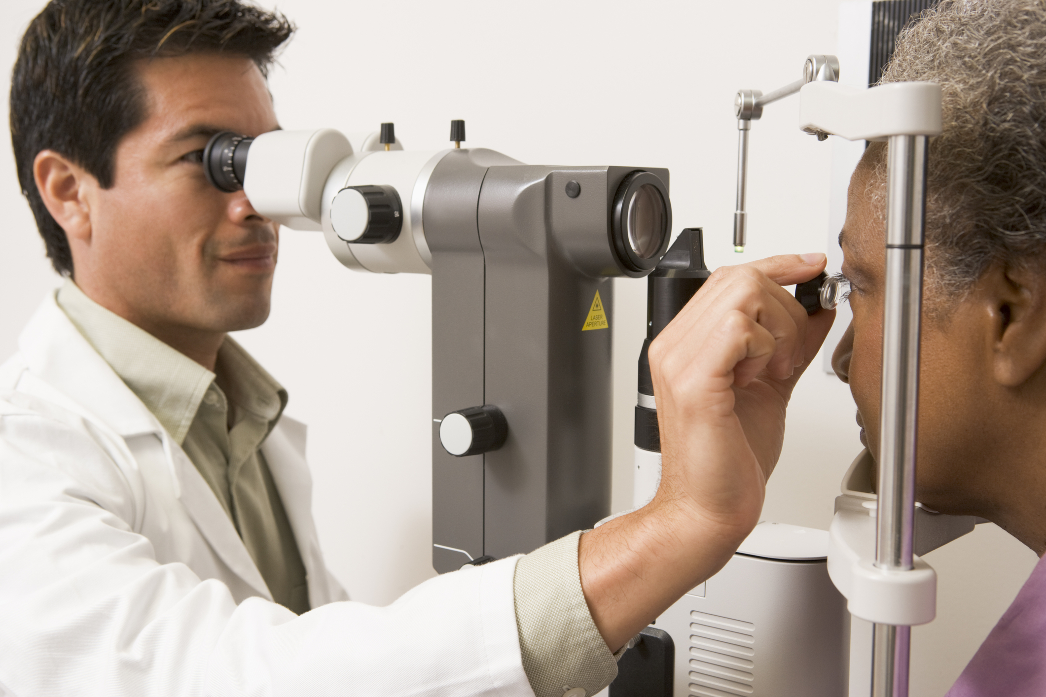 eye doctor using equipment to examine patient's eye.