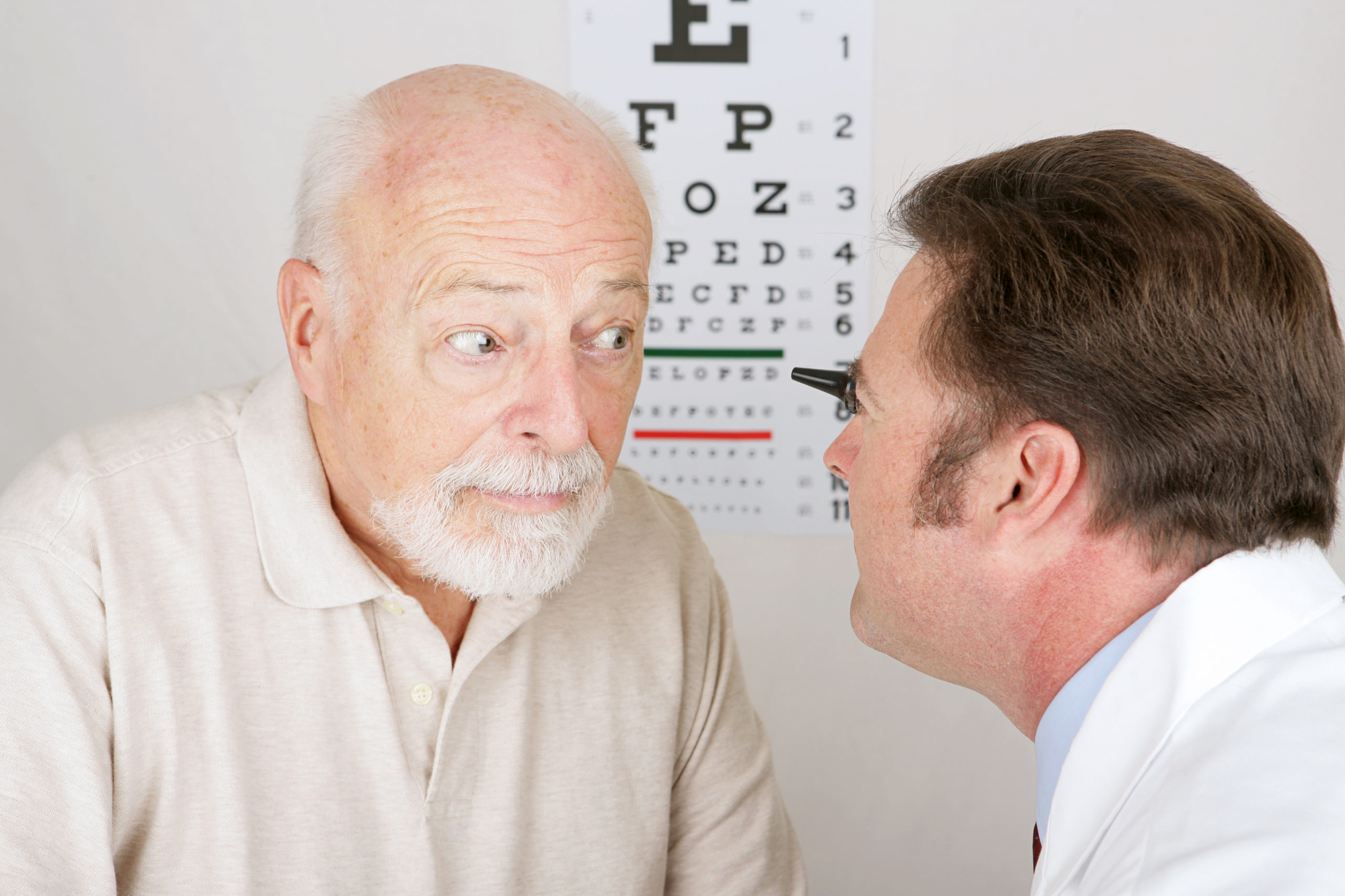 eye doctor examining patient's eye up close