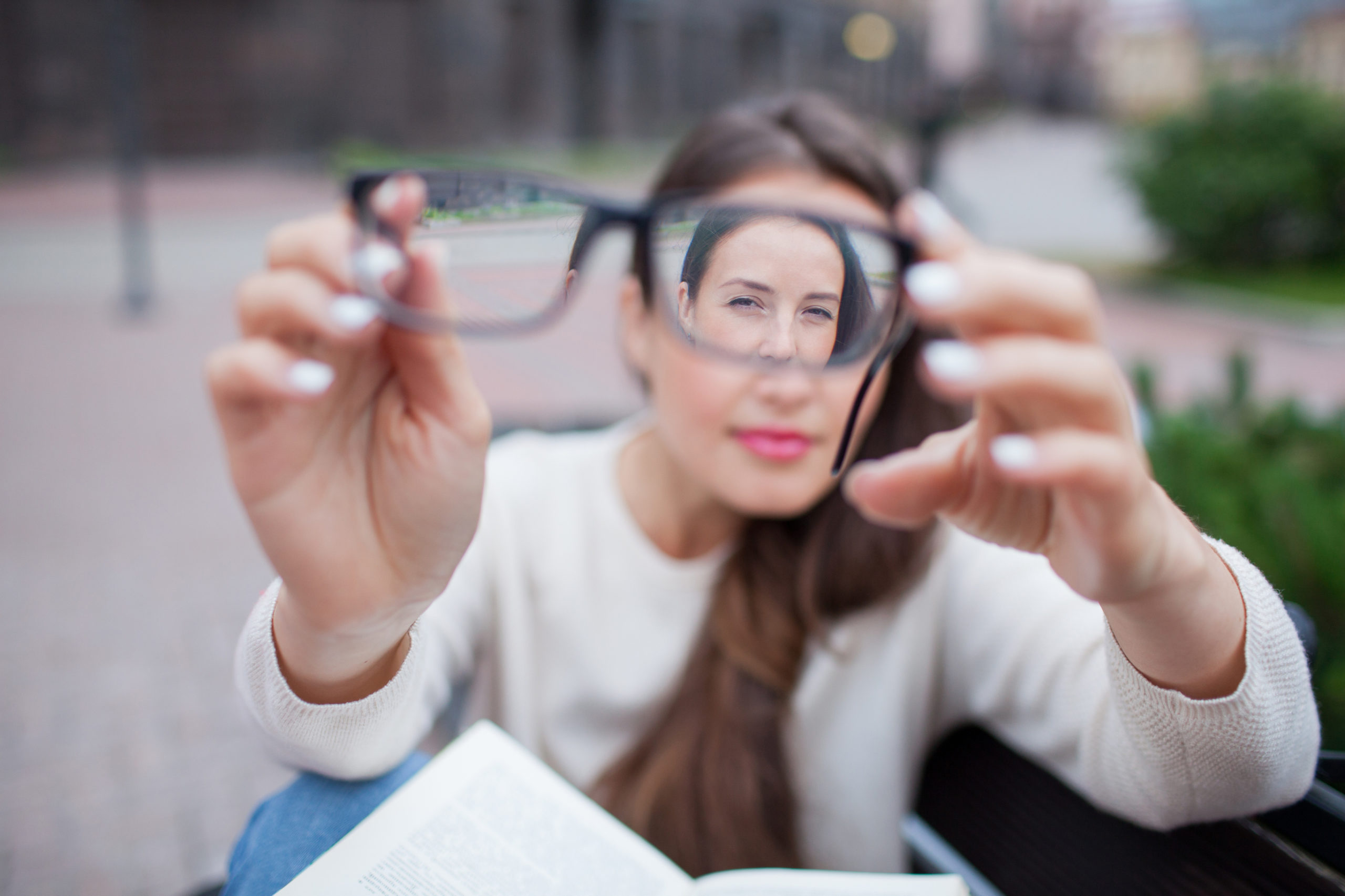 woman looking at prescription glasses