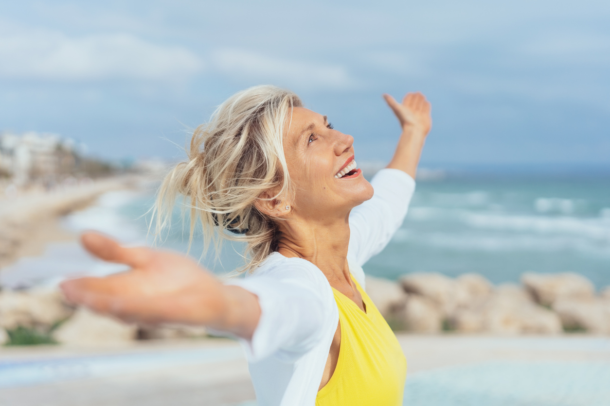 Joyful woman enjoying the freedom of the beach