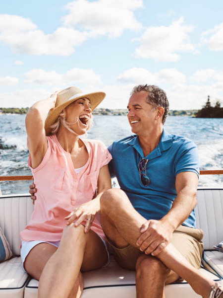 Middle aged couple sitting on a boat - Refractive Lens Exchange