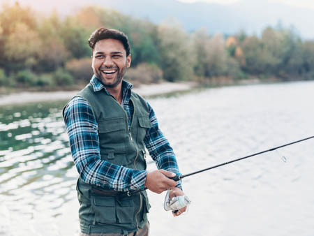 young man fishing after lasik surgery in Fort Collins colorado
