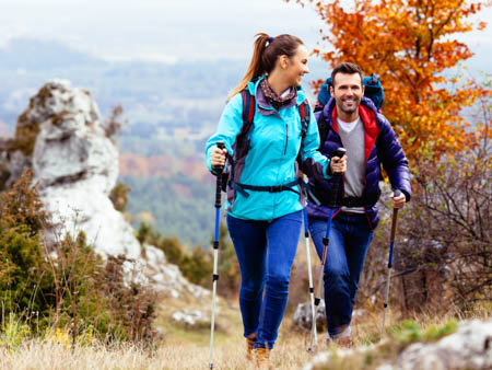 young couple hiking after lasik surgery in Windsor colorado