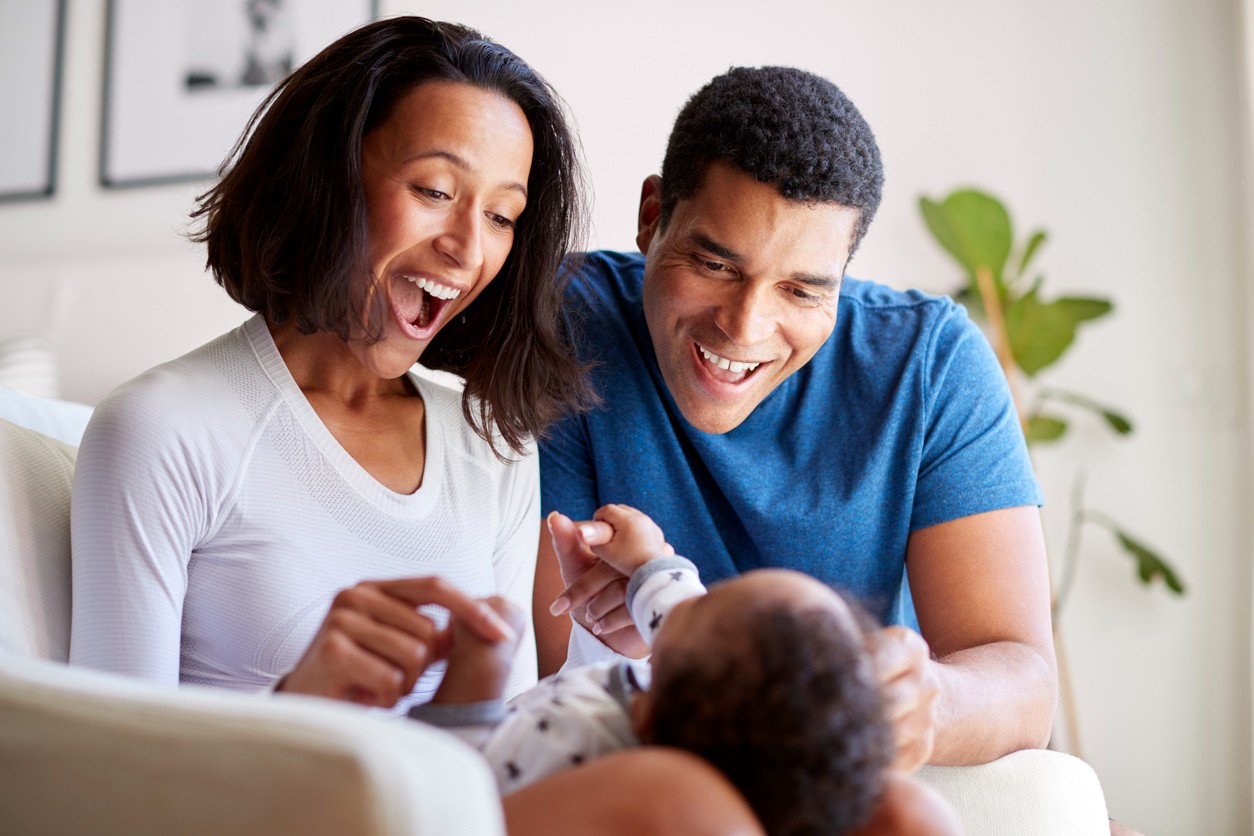 multi-racial-couple-looking-at-baby